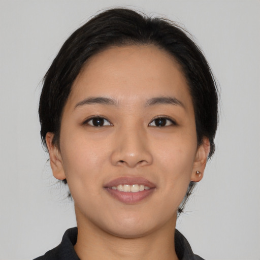 Joyful asian young-adult female with medium  black hair and brown eyes