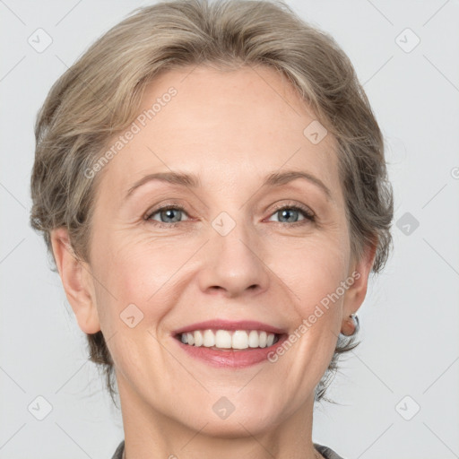 Joyful white adult female with medium  brown hair and grey eyes