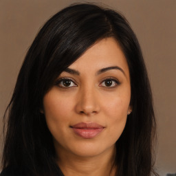 Joyful latino young-adult female with long  brown hair and brown eyes