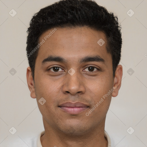 Joyful black young-adult male with short  black hair and brown eyes