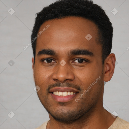 Joyful black young-adult male with short  brown hair and brown eyes