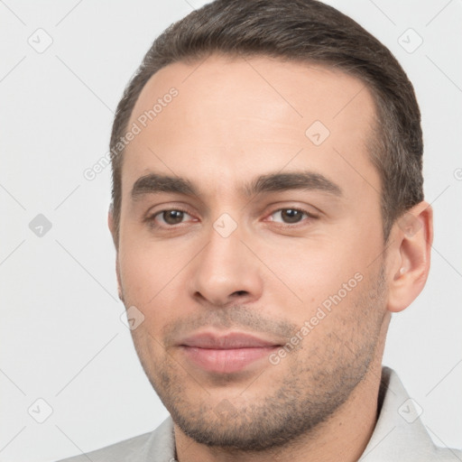 Joyful white young-adult male with short  brown hair and brown eyes