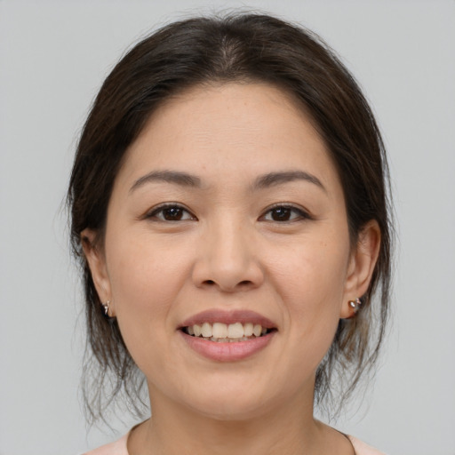 Joyful white young-adult female with medium  brown hair and brown eyes