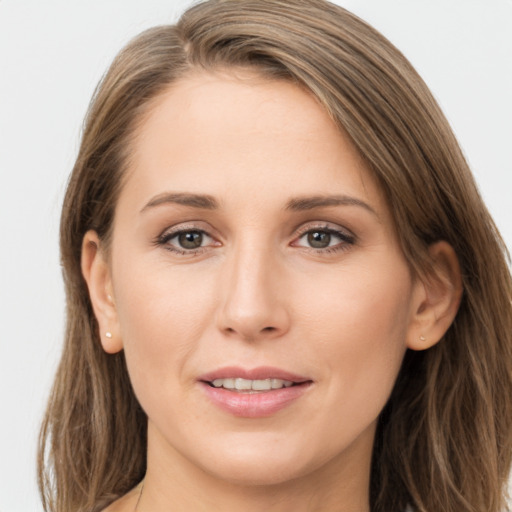 Joyful white young-adult female with long  brown hair and grey eyes