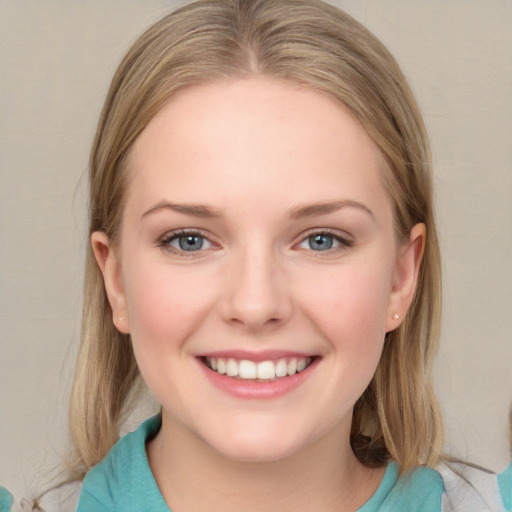 Joyful white young-adult female with medium  brown hair and blue eyes