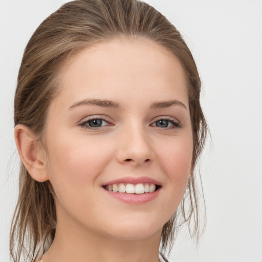 Joyful white child female with medium  brown hair and grey eyes