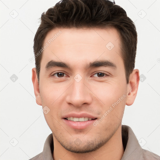 Joyful white young-adult male with short  brown hair and brown eyes