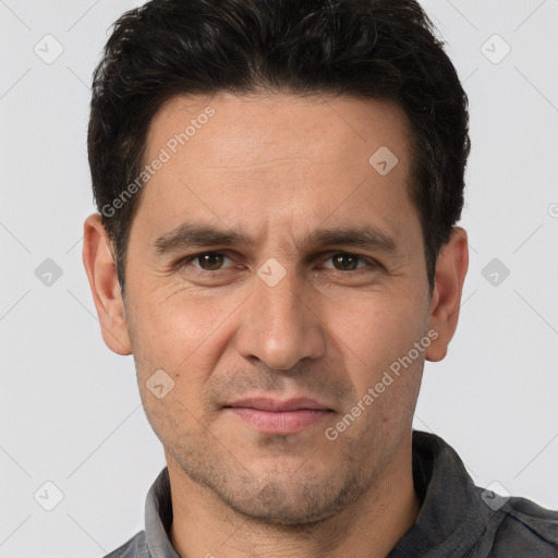 Joyful white adult male with short  brown hair and brown eyes