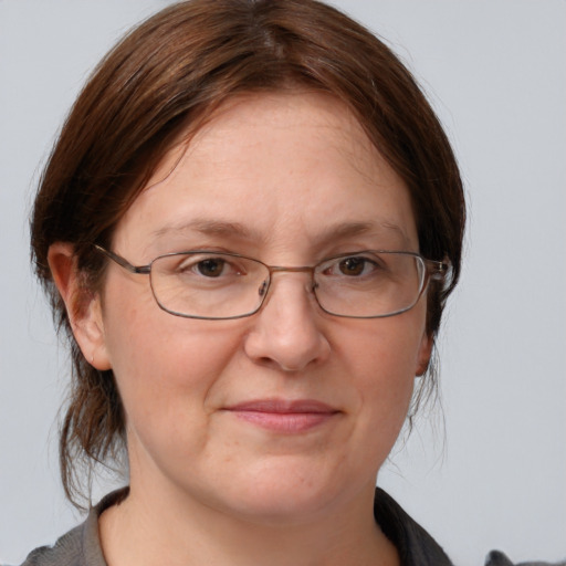 Joyful white adult female with medium  brown hair and grey eyes