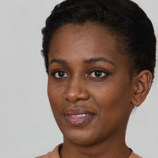 Joyful black young-adult female with short  black hair and brown eyes