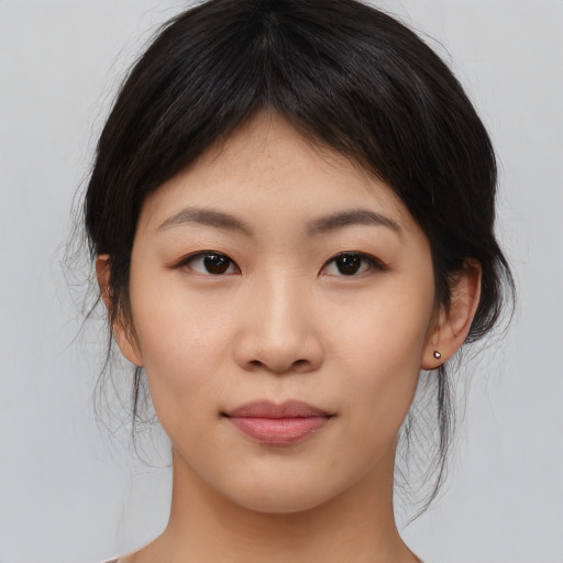 Joyful asian young-adult female with medium  brown hair and brown eyes