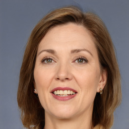 Joyful white adult female with medium  brown hair and grey eyes