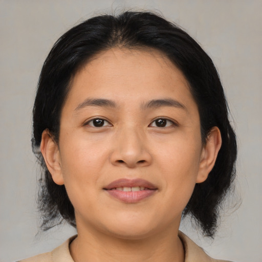 Joyful asian young-adult female with medium  black hair and brown eyes