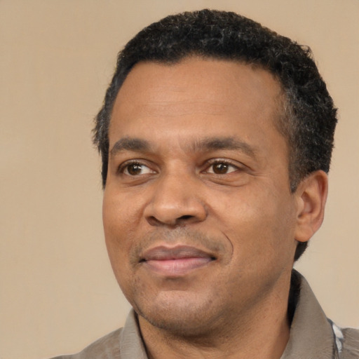 Joyful latino adult male with short  black hair and brown eyes