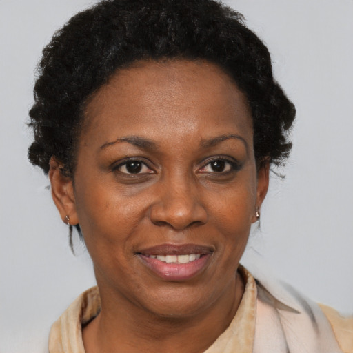 Joyful black adult female with short  black hair and brown eyes