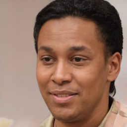 Joyful latino adult male with short  brown hair and brown eyes