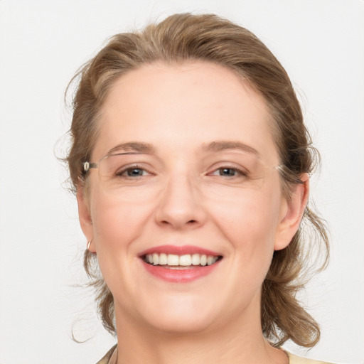 Joyful white adult female with medium  brown hair and grey eyes