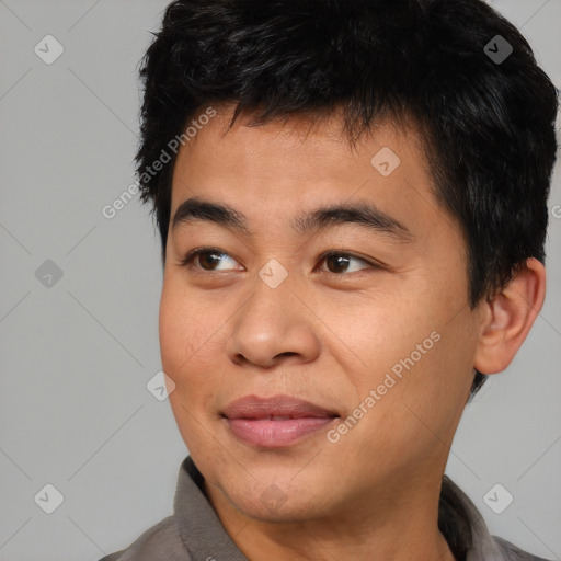 Joyful asian young-adult male with short  brown hair and brown eyes