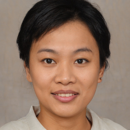 Joyful asian young-adult female with short  brown hair and brown eyes
