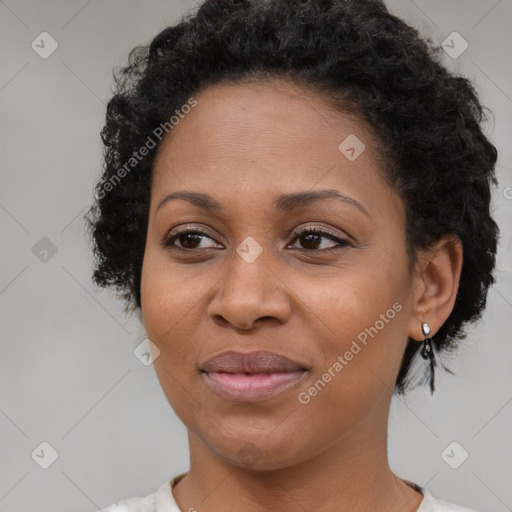 Joyful black adult female with medium  brown hair and brown eyes