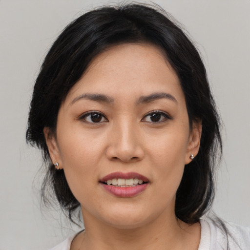 Joyful white young-adult female with medium  black hair and brown eyes