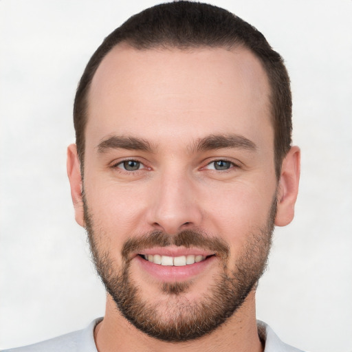 Joyful white young-adult male with short  brown hair and brown eyes