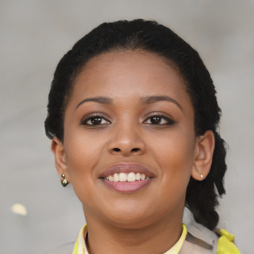 Joyful black young-adult female with short  brown hair and brown eyes