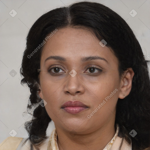 Joyful black young-adult female with long  brown hair and brown eyes