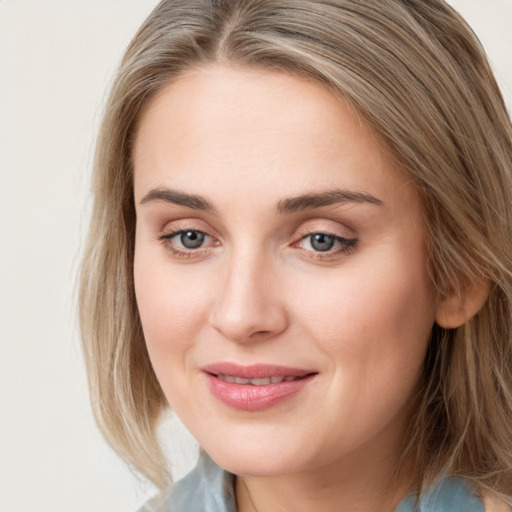 Joyful white young-adult female with medium  brown hair and blue eyes