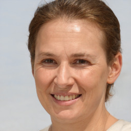 Joyful white adult female with short  brown hair and brown eyes