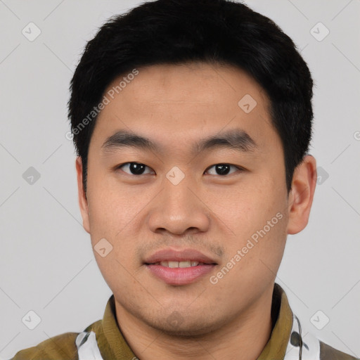 Joyful asian young-adult male with short  black hair and brown eyes