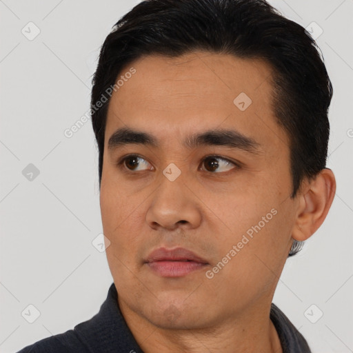 Joyful asian young-adult male with short  black hair and brown eyes