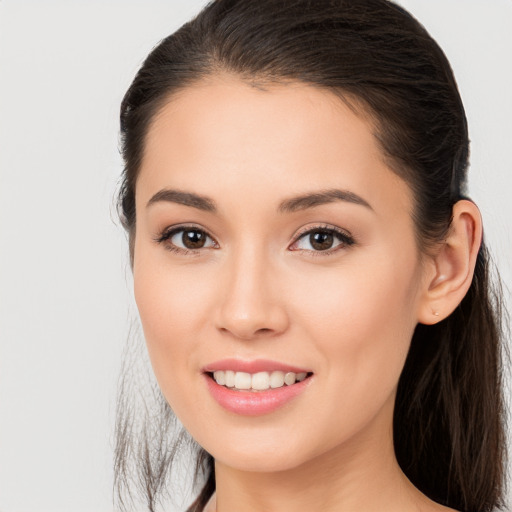 Joyful white young-adult female with long  brown hair and brown eyes