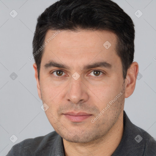 Joyful white young-adult male with short  black hair and brown eyes