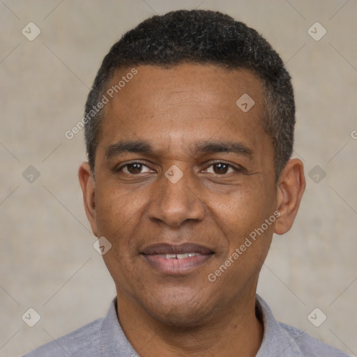 Joyful black adult male with short  black hair and brown eyes