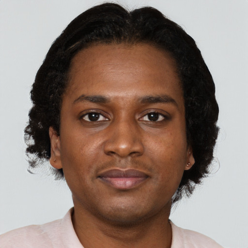 Joyful black young-adult female with short  brown hair and brown eyes