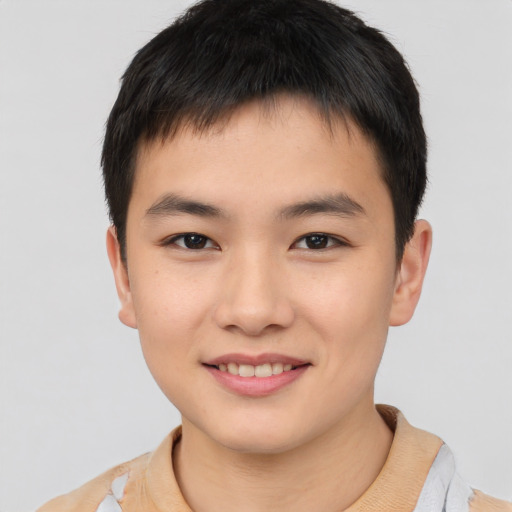 Joyful asian child male with short  brown hair and brown eyes