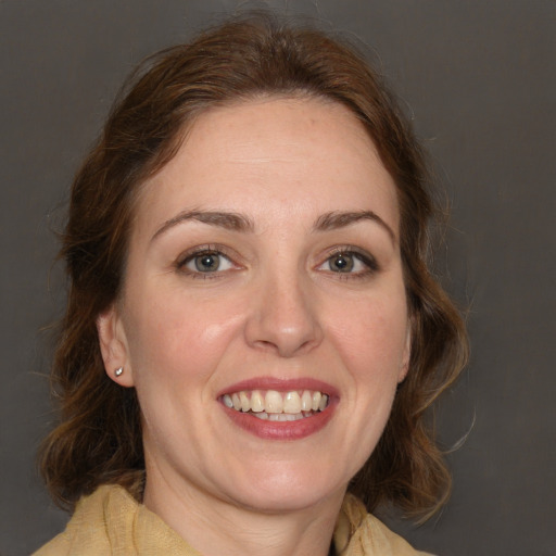 Joyful white adult female with long  brown hair and brown eyes