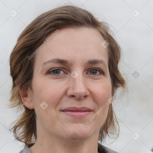 Joyful white adult female with medium  brown hair and grey eyes