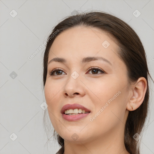 Joyful white young-adult female with long  brown hair and brown eyes