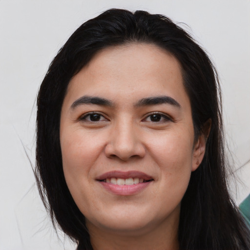 Joyful asian young-adult female with long  brown hair and brown eyes