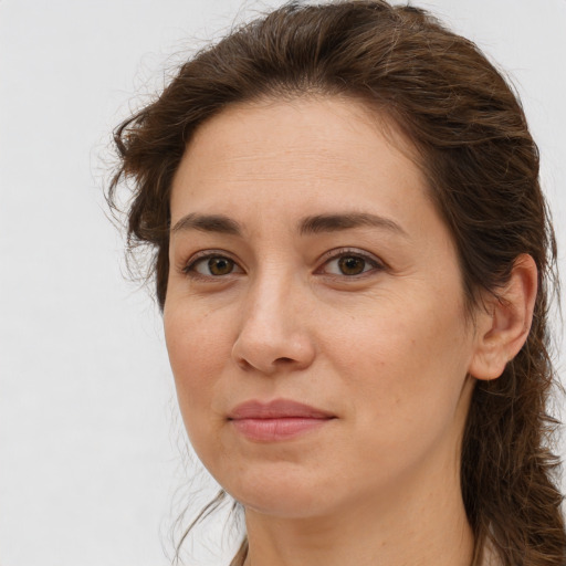 Joyful white adult female with long  brown hair and brown eyes