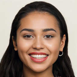 Joyful latino young-adult female with long  black hair and brown eyes