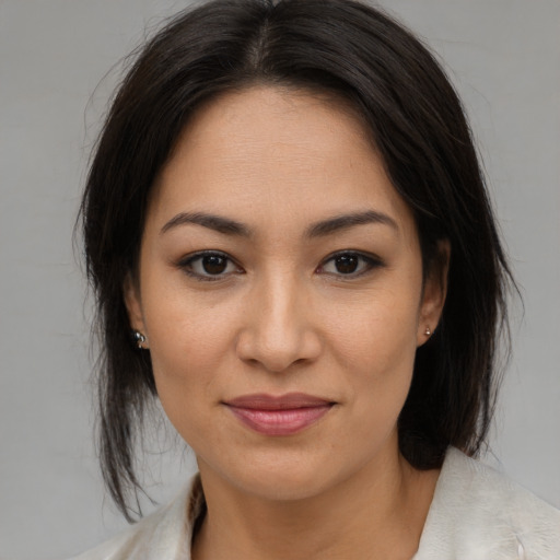 Joyful asian young-adult female with medium  brown hair and brown eyes