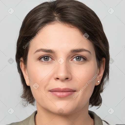 Joyful white young-adult female with medium  brown hair and grey eyes