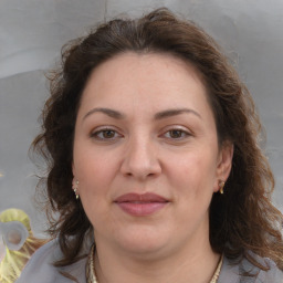 Joyful white adult female with medium  brown hair and brown eyes