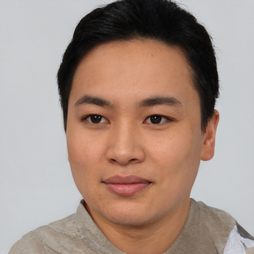 Joyful asian young-adult male with short  black hair and brown eyes