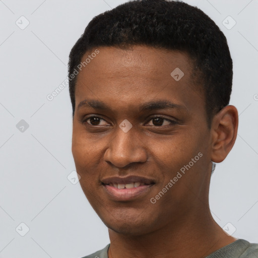 Joyful black young-adult male with short  black hair and brown eyes