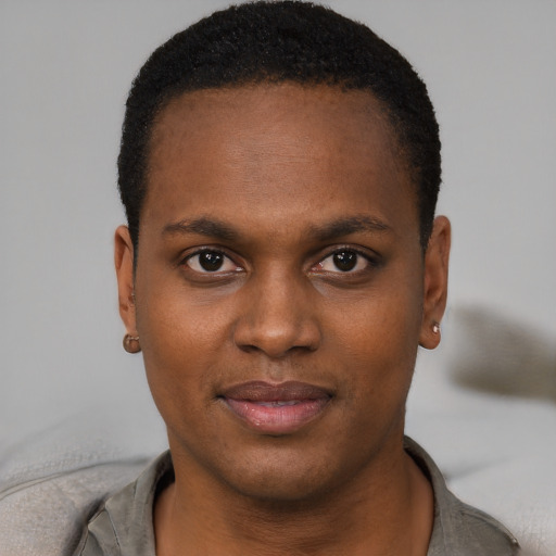 Joyful black young-adult male with short  brown hair and brown eyes