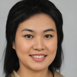 Joyful asian young-adult female with medium  brown hair and brown eyes